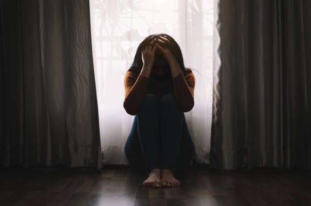 woman sit Depression Standing by window and anxiety Copy space.